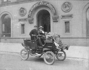 George and Marguerite Carmack, sitting in a steam driven locomobile in front of Mobile Company of America building, ca. 1902
