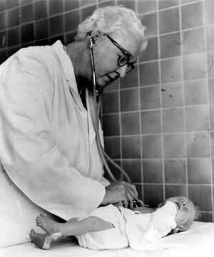 Dr. Apgar examining an infant